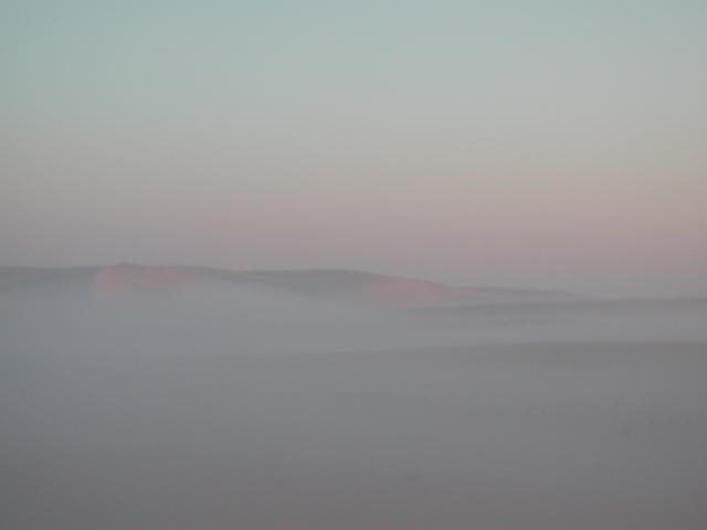 Dunes above the early morning fog