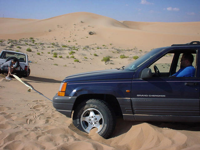 Noel towing out Ahmet's car after it got stuck in the sand.