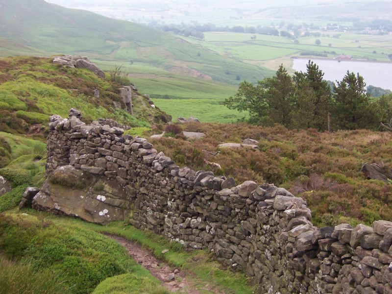 rock fence on moor, with reservoir in background
