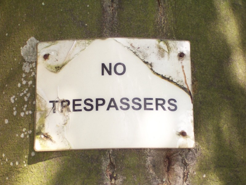 the sign on a tree at the start of the field access road