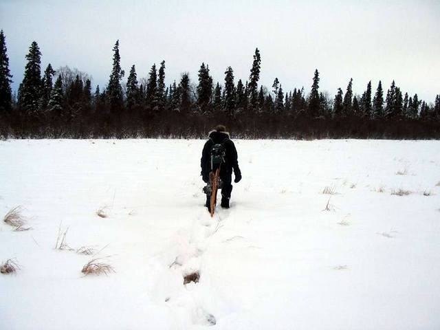 Chris hiking across a frozen lake