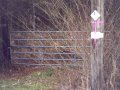 #3: Another locked fence with the white GP Timber Co. sign