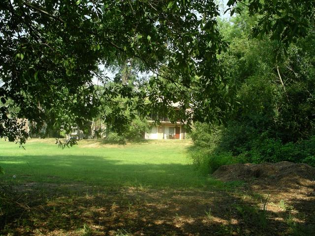 looking east to the grassy area and an apartment building.