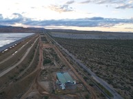 #10: View West (along W. Pima Mine Road and the side of the reclamation pond, towards a large mine) from 120 m above the point)