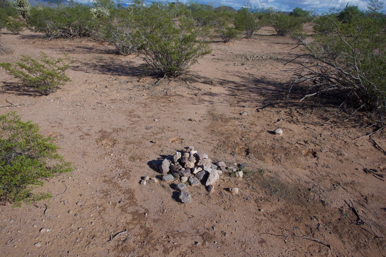 The confluence point lies in a flat, sparsely-vegetated desert region