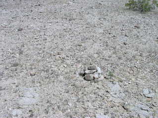 #1: The confluence point - in rocky desert terrain - is marked by a small rock cairn left by previous visitors
