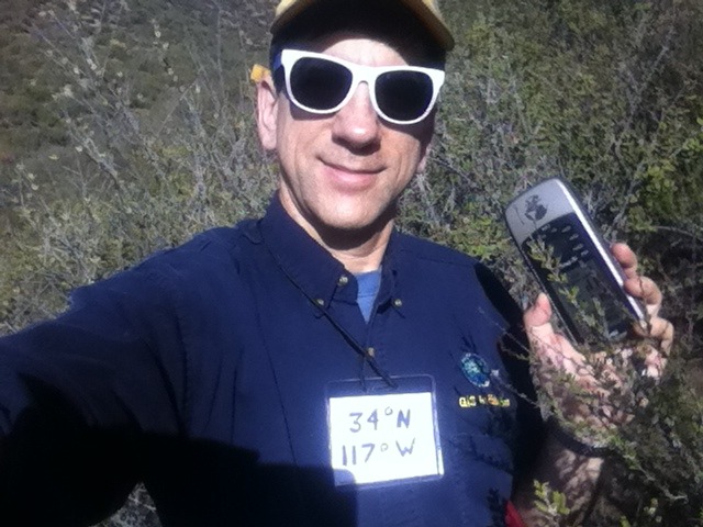 Joseph Kerski at the confluence point in his 50 cent sunglasses.