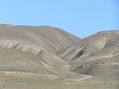 #8: Looking north at the confluence, which is midway up the hills on the left side.