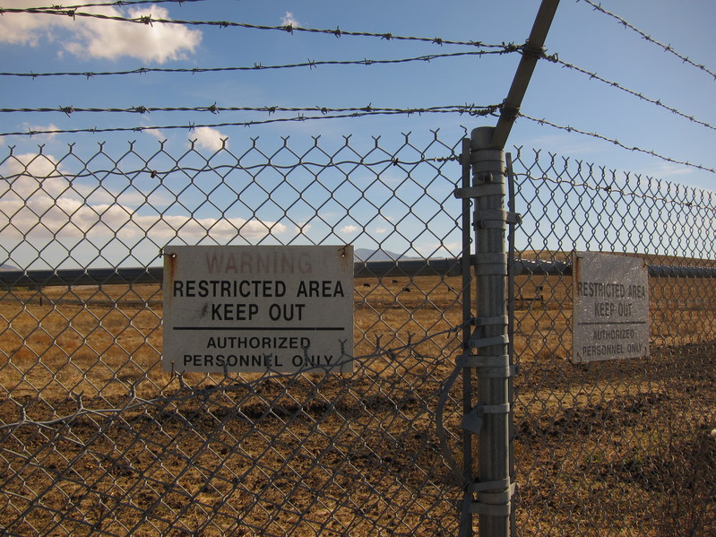 Restricted area notices on the chain link fence