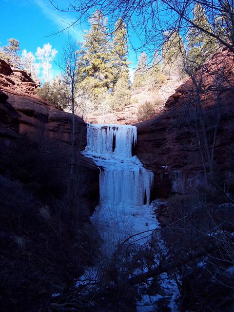 A frozen waterfall near foot of mountain