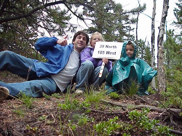 Joseph, Emily, and Lilia Kerski arrive at confluence site as light rain falls.