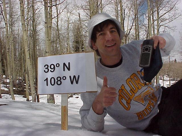 Joseph Kerski lying in the snow at the confluence site.