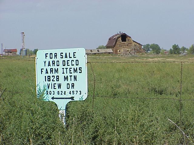 Signs of the times...selling farm items and an abandoned barn, looking north from the confluence.