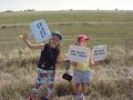 #5: Young confluence hunters jubilantly display signs and GPS as site is found.