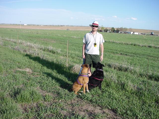 Dad and the dogs, with a farm in the background.