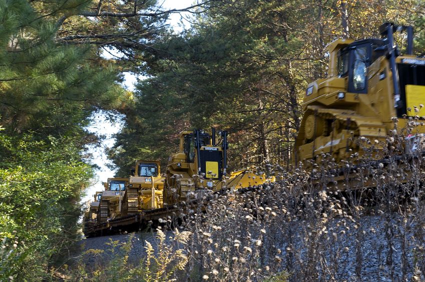 A train - carrying new Caterpillar vehicles - passes between the road and the confluence point.  (It's nice to see that manufacturing in the U.S. is still alive!)