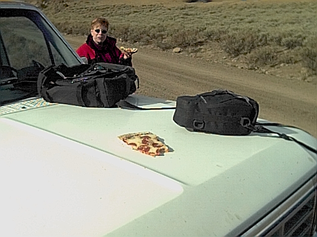 Cold pizza warming on the hood of the truck.
