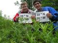 #3: Bob Coulter and Joseph Kerski proudly display signs in the tall plants at the confluence site.
