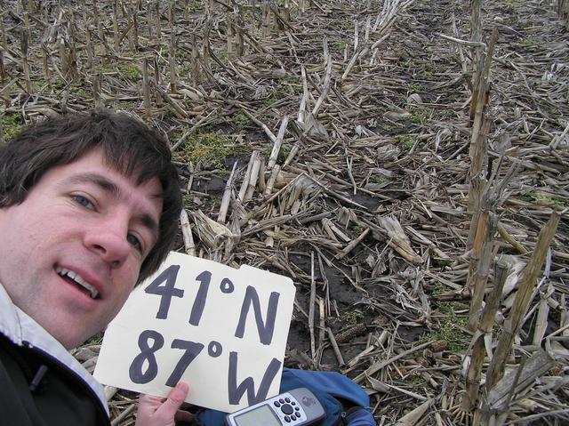 Joseph Kerski lying on top of 41 North 87 West in an Indiana cornfield.