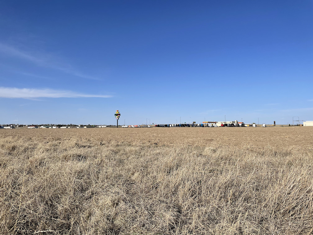 View NE to the confluence in the foreground, Love's / Dollar General in the background