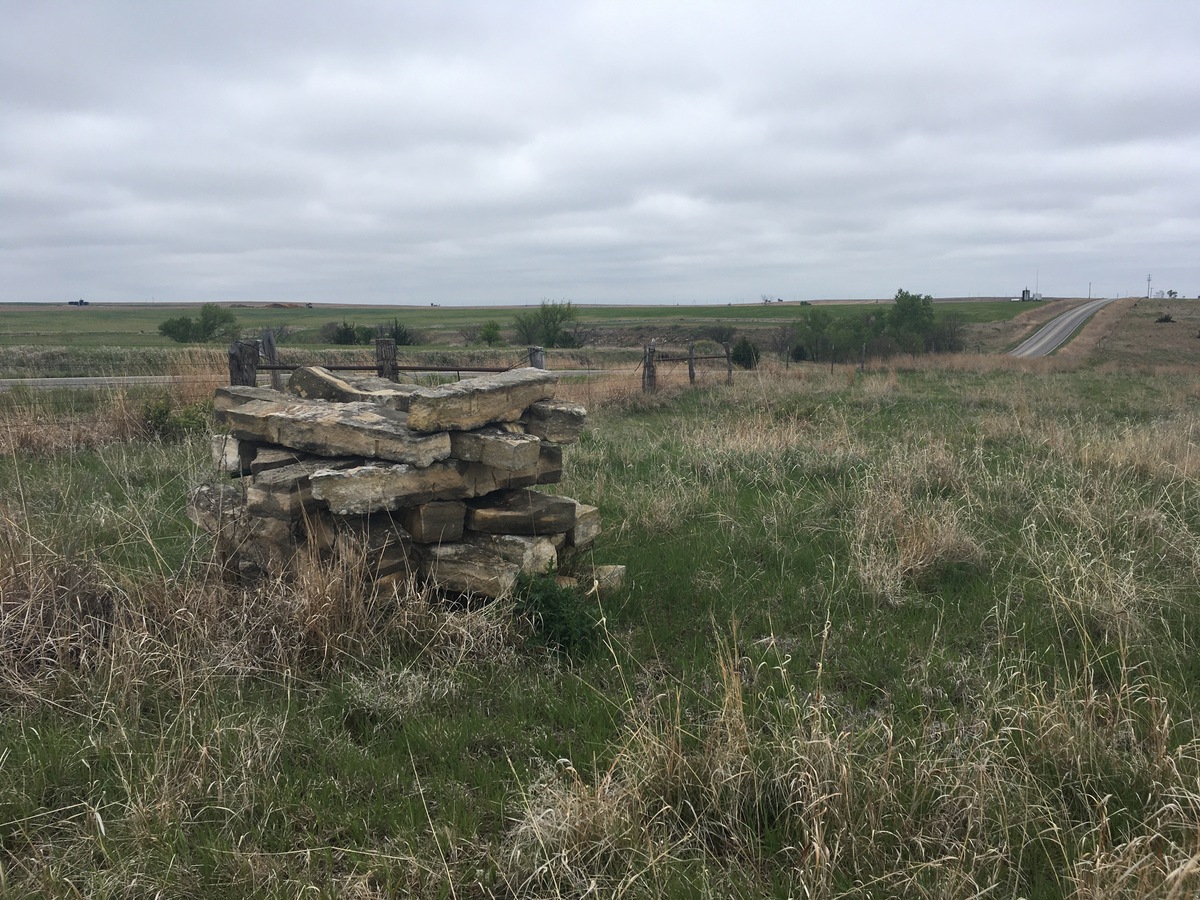 A pallet of fencepost limestone by where we ducked under the unmarked barbed wire gate