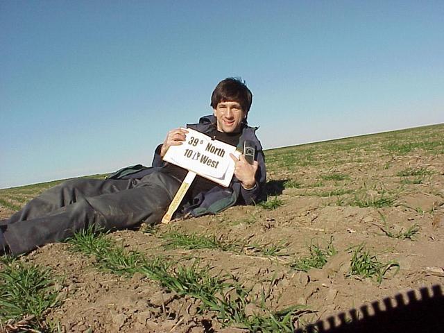 Joseph Kerski lying in the field at the confluence site.