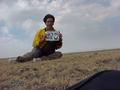 #3: Joseph Kerski, Geographer, trying to hold the sign in the wind at the confluence.