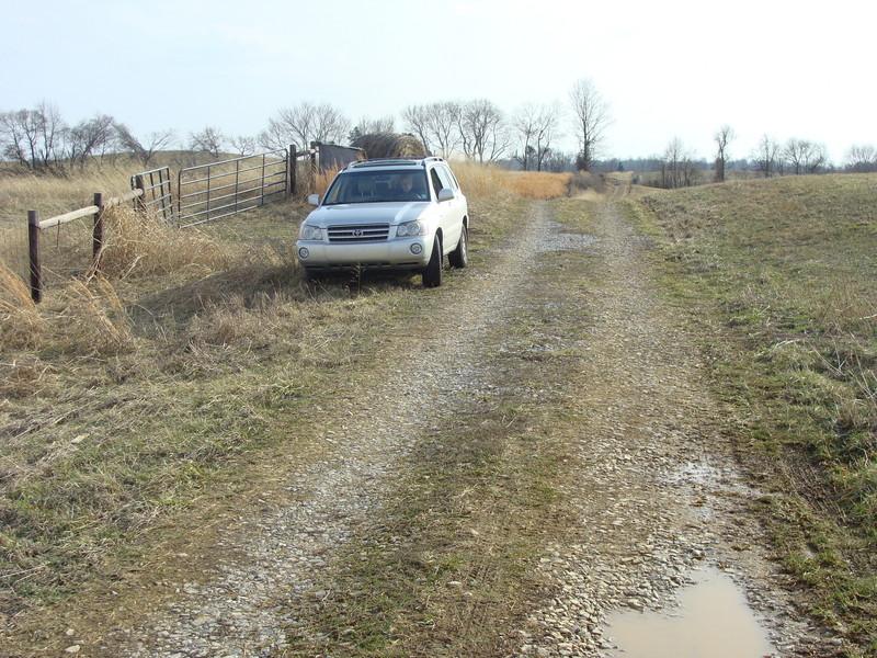 Support vehicle waits at the gate to the 37N 86W field