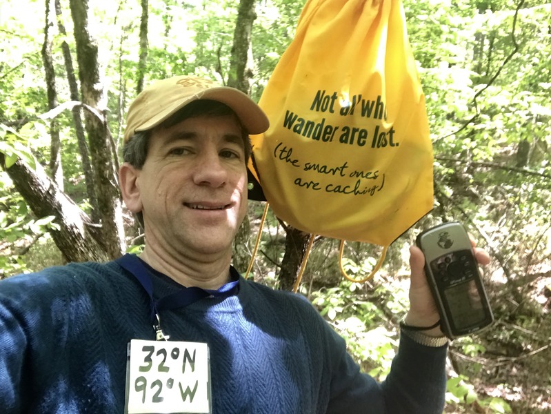 Joseph Kerski at the confluence point with Not All Who Wander are Lost bag. 