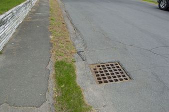 #1: The confluence point lies on this suburban road, close to this storm drain