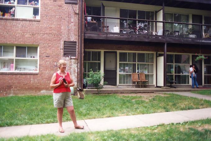 Cheryl in front of the appartment containing the confluence.