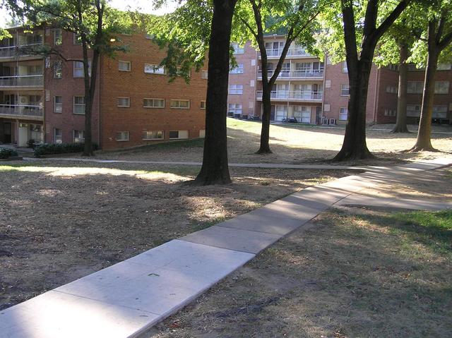 The confluence of 39 North 77 West lies just to the left of the large tree in the center of the photograph, inside the apartment building.