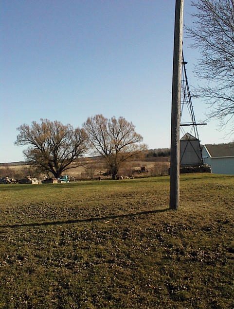 Just north of confluence, 1. (It is where the right tree is.)