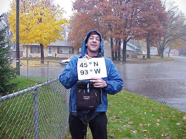 Joseph Kerski standing in the pouring Minnesota rain halfway to the pole.