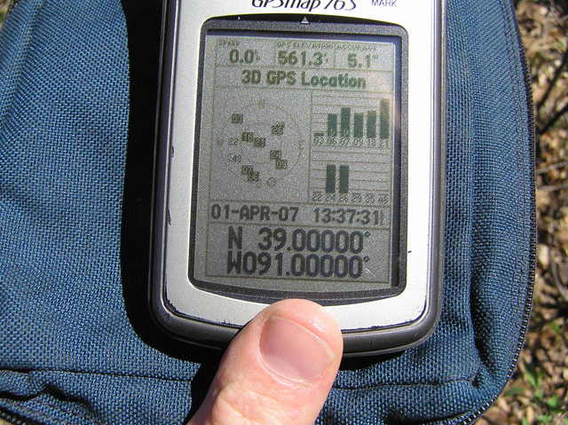 GPS at the confluence site, 1.5 meters south of the fenceline.