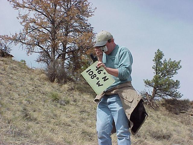 Geographer Steve Reiter takes a photograph of his GPS receiver at confluence site.