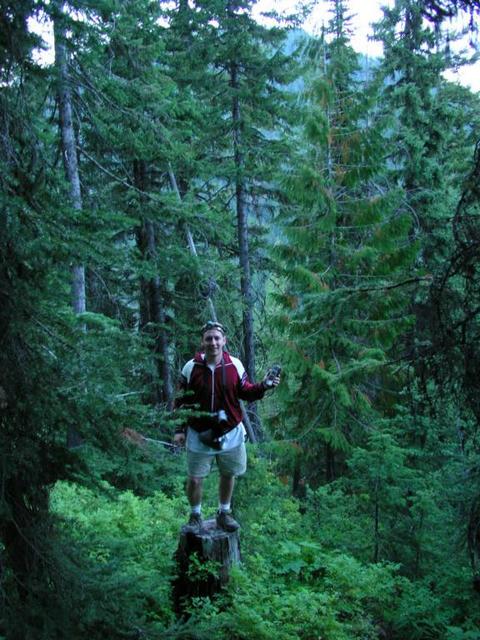 Erik on stump having recovered dropped GPS unit