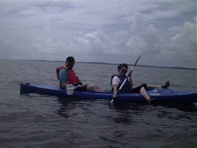 Laurie and Jason, low in the water and with the sun and southern shore behind them.