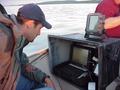 #6: Ryan Krapp, left, monitors Trimble GPS and Garmin Sonar equipment used to map the floor of Devils Lake, North Dakota.