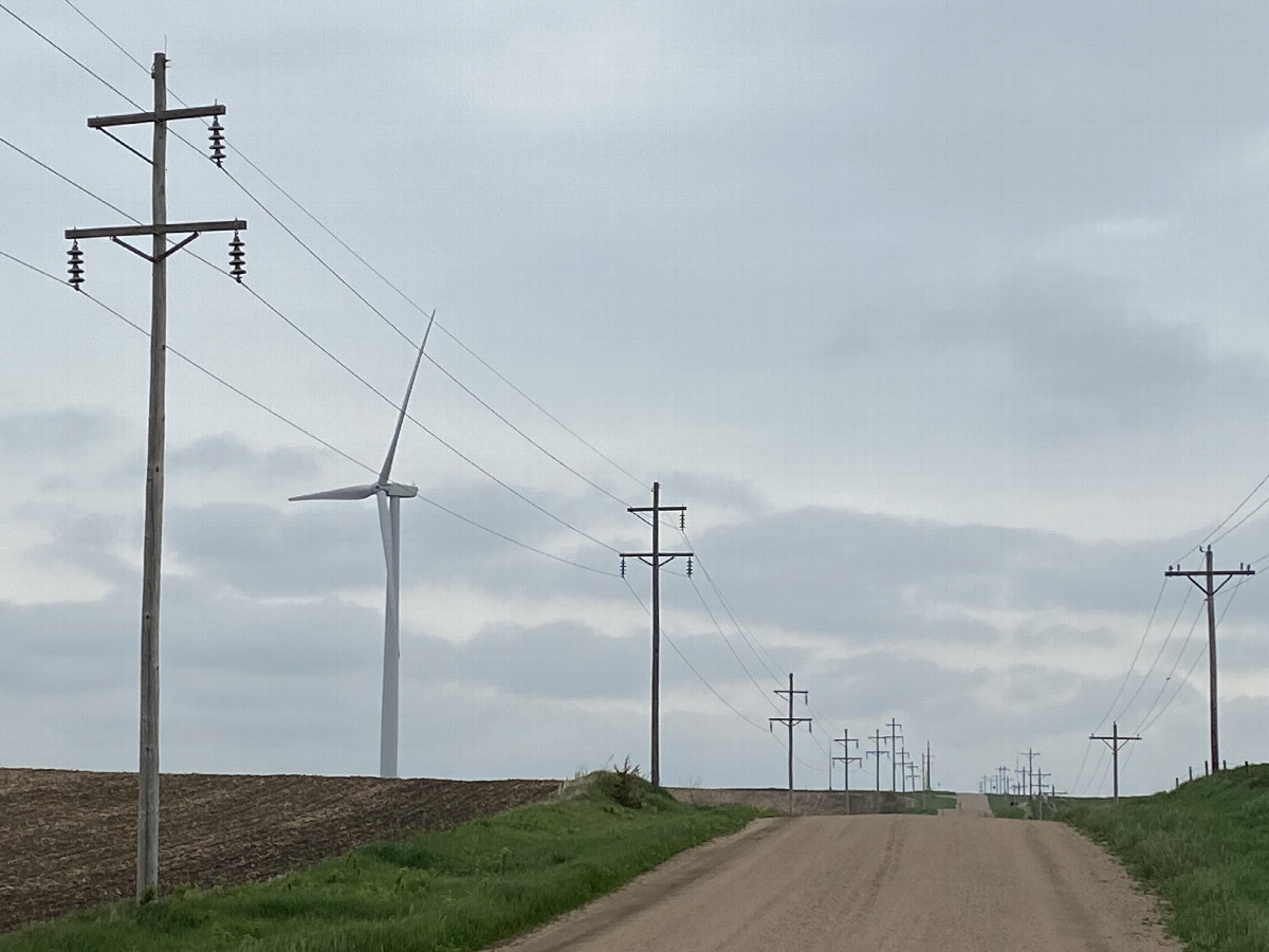 Confluence surroundings:  Grain bins, fields, telephone lines, and wind turbines. 