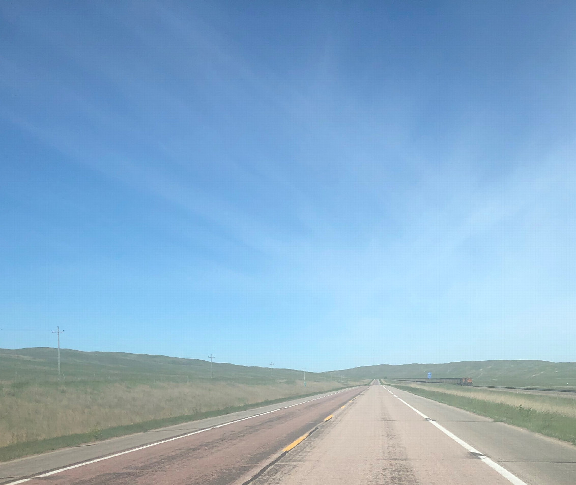 Huge sky headed west on N-2, with a miles long coal train headed towards us on the right