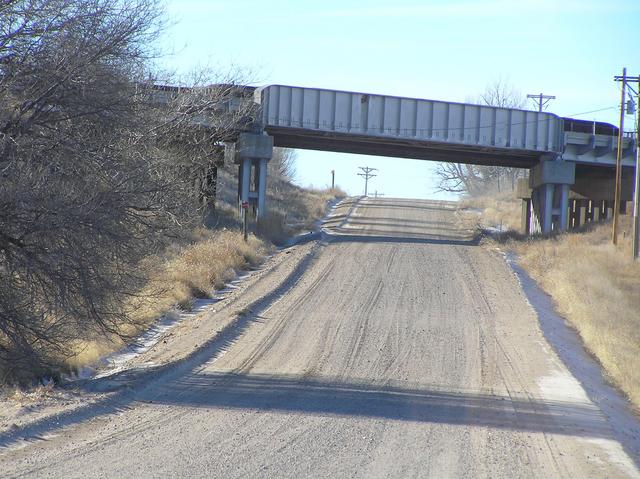 Road about 200 meters north of the confluence, looking west to the railroad overpass.