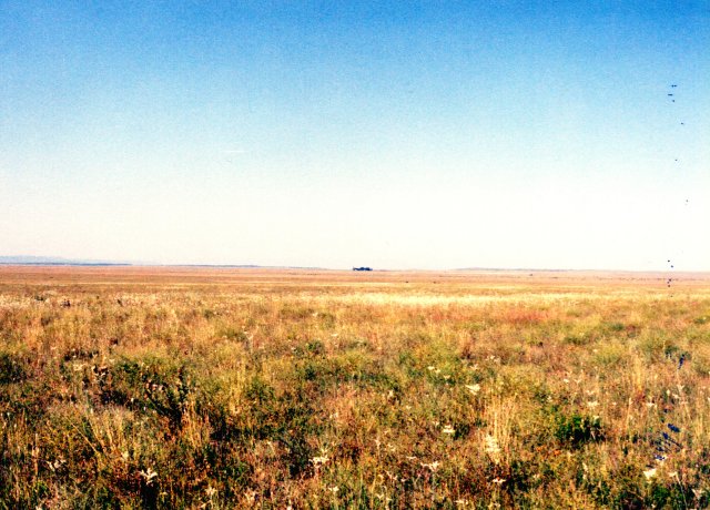 View to SSE of confluence; ranch house in trees.