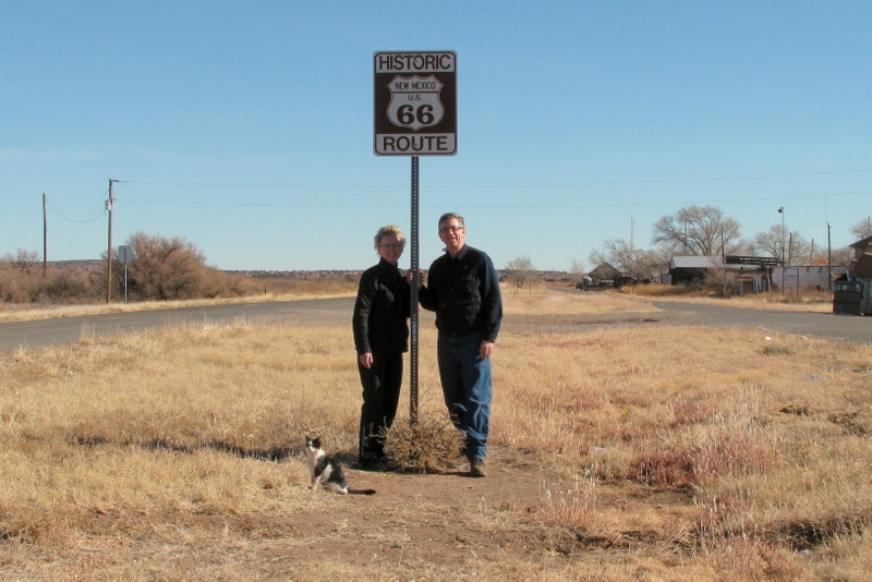 Wind blown confluence hunters with historic Route 66 sign ... and friendly local cat 