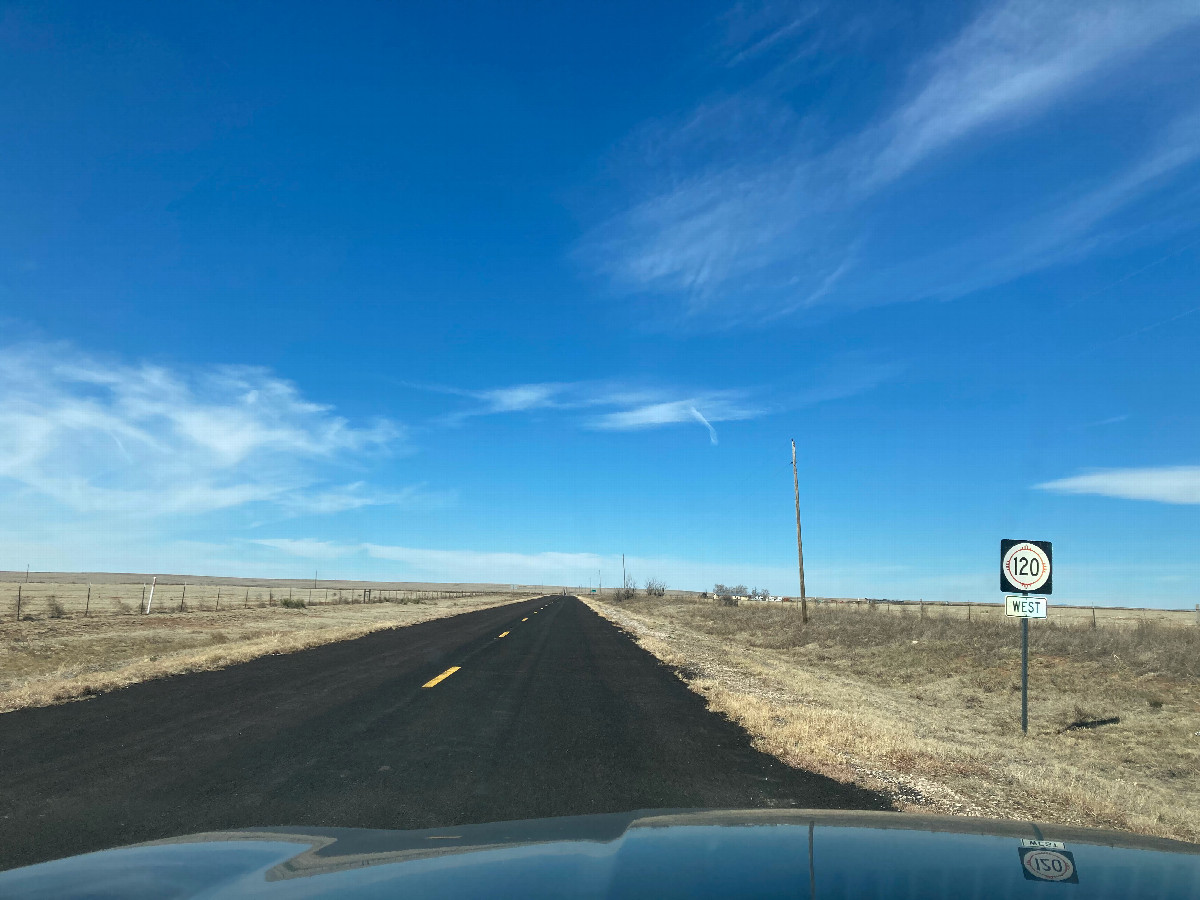 Looking west along NM 120, 6 km northwest of the confluence (photo taken while stationary!)