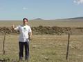 #6: Joseph Kerski with the confluence behind him.