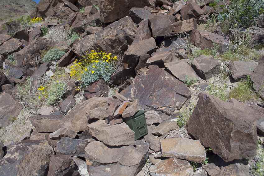 The confluence point, on a rocky hillside, is now marked by a 'geocache' box