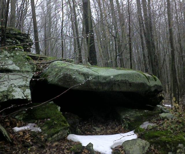 "Bear's den" (well, almost) at the confluence.  Small cave on the hillside formed by a boulder.