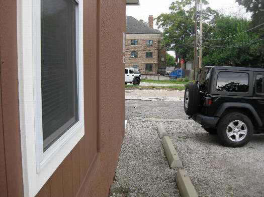 #1: View to the west; confluence is on the roof above this window
