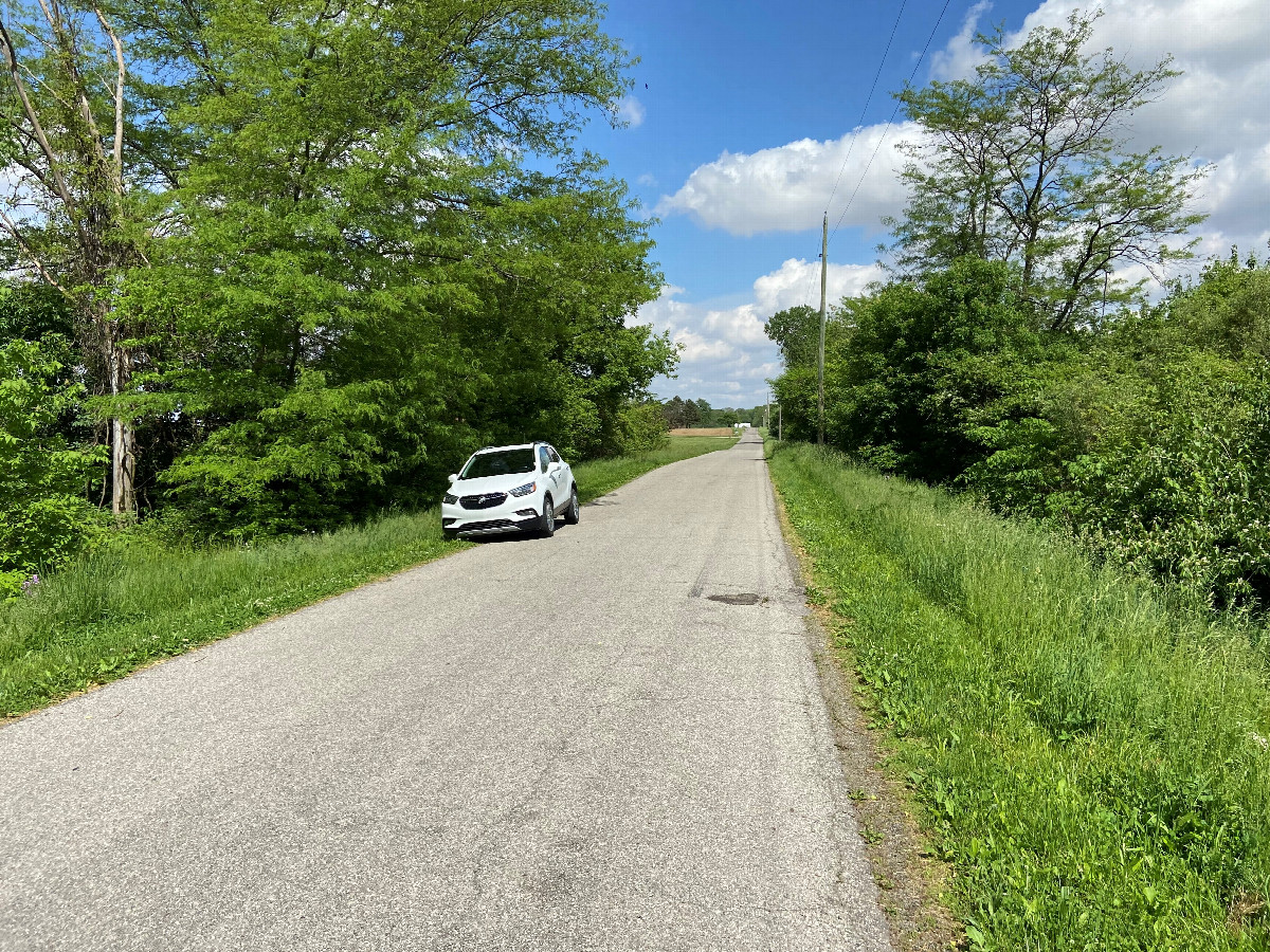 View of vehicle and closest road to the confluence, looking east. 